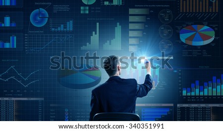 Rear view of businessman drawing with marker infographs on wall