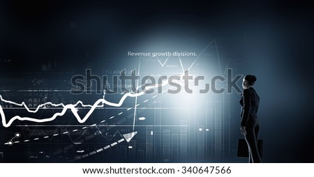 Back view of businesswoman with suitcase in hands looking at virtual panel