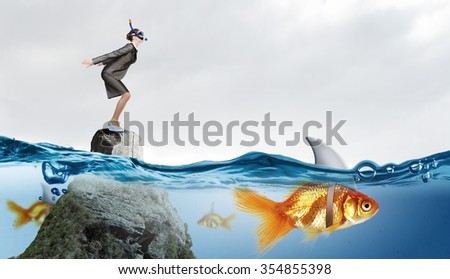 Concept of fake threat when businesswoman jump in water with shark appear to be goldfish