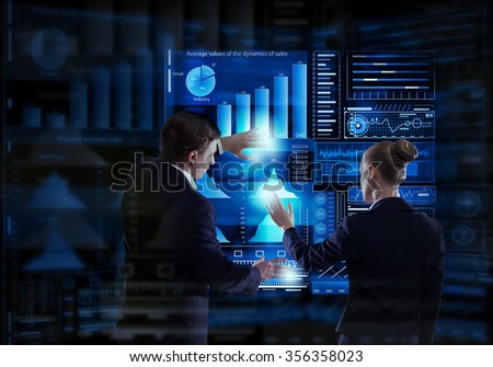 Rear view of businessman and businesswoman working with virtual panel interface