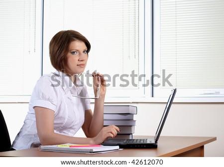 young woman in white dress in office