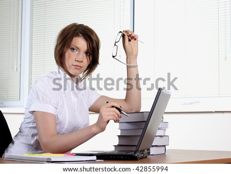 young woman in white dress in office
