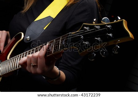 hand play on electrical guitar strings in music study