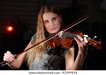 young female play on violin in music study