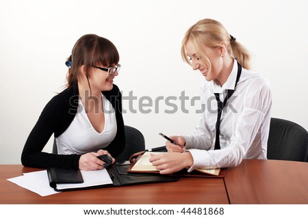 two charming business woman talking in office
