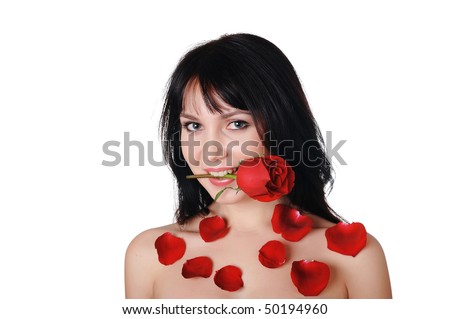 Young lovely brunette with a beautiful red rose petals strewn with roses