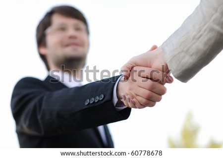 Business men and women shaking hands on a light background. Meeting.
