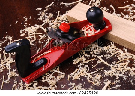 Shavings of wood, brick and red plane