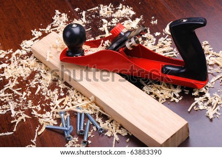 Shavings of wood, brick and red plane
