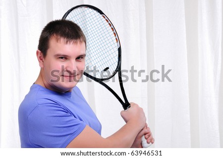 Young man with tennis racket on a white background
