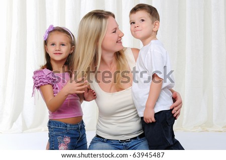 A young mother, her daughter and son having fun together