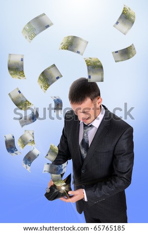 A young man with a wallet from which cash flow ejected