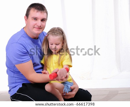A young father and daughter together in sports