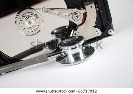 Computer hard drive and a stethoscope. The symbol of health equipment.