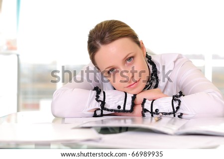 Young business woman in an office at the workplace.