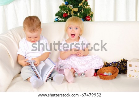 two small children - a boy and girl getting ready for the holiday. Happy New Year!