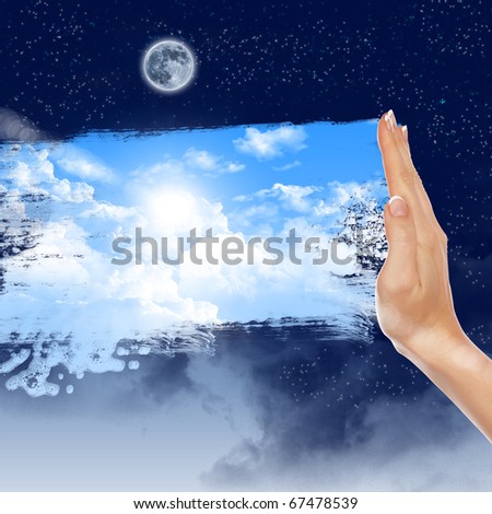 Hand wipes misted window at a blue sky