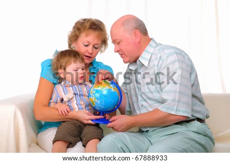 Grandmother, grandfather and grandson spend time together. Symbol of the family.