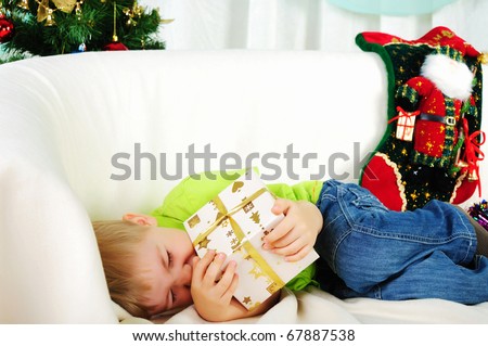 the little boy fell a sleep on the couch waiting for a holiday. Happy New Year and Merry Christmas!