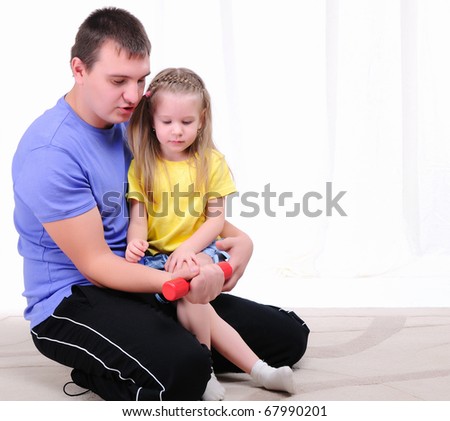 A young father and daughter together in sports