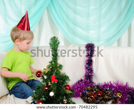 little boy getting ready for the holiday. Happy New Year and Merry Christmas!
