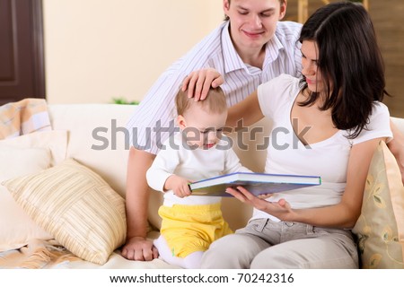 young happy family  playing with a baby in the living-room