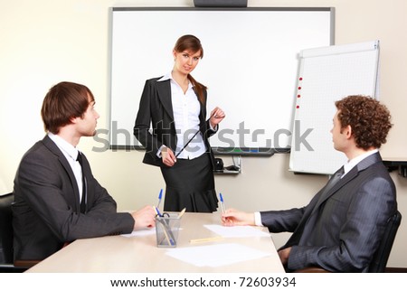 a young business woman making presentation in an office