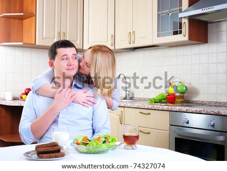 The wife and husband have breakfast together in his kitchen.