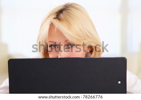 portrait of young lady with notebook in office