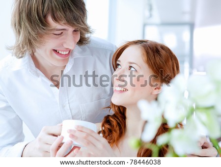young couple in love together presenting a gift