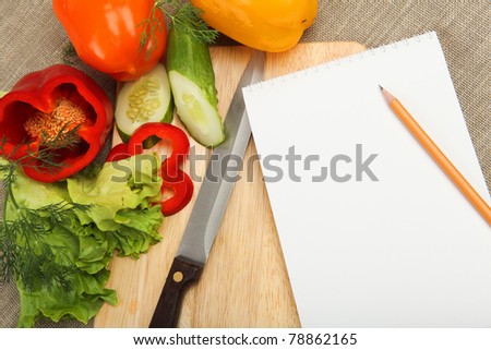Place for cooking vegetables, vegetables, and a notebook. symbol of a healthy lifestyle.
