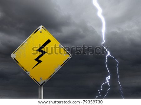 yellow warning sign of bad weather ahead against stormy sky