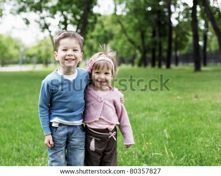happy sister and brother together in the park