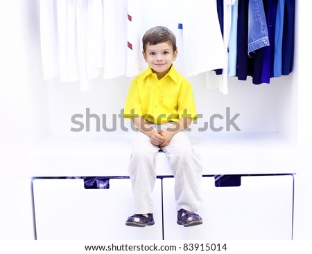 Little boy in yellow shirt doing shopping