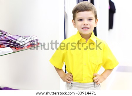 Little boy in yellow shirt doing shopping