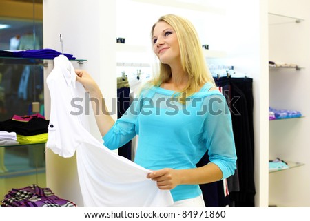 young girl in a shop buying clothes
