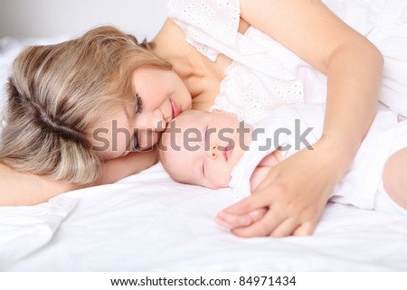 Portrait of a young mother and baby and a girl in her arms