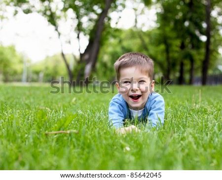 Portrait of a happy little boy in the park
