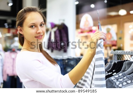 Young woman doing shopping in clothes store
