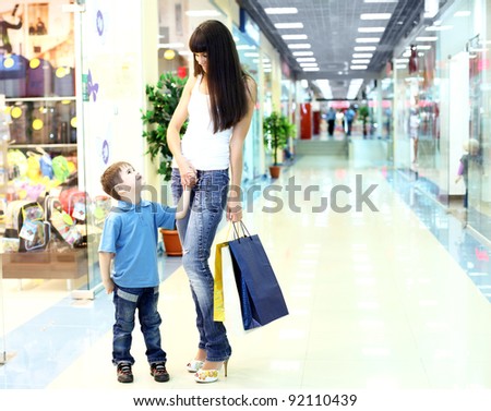 Young mother with shopping bags doing shopping