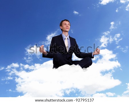 Young businessman in blue suit sitting and praying