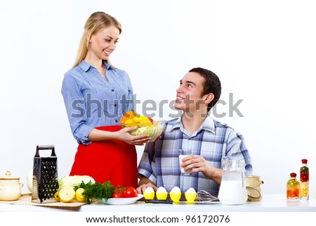 Happy husband and wife cooking together at home