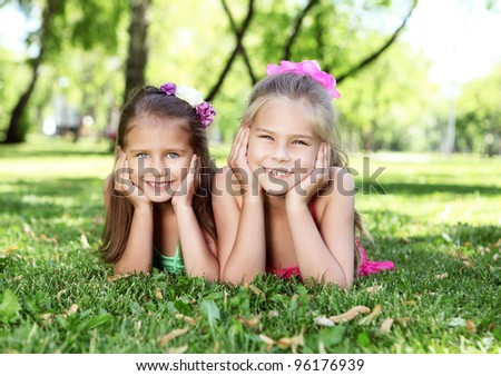 Little kid friends in the summer park