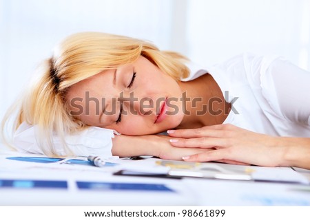 portrait of young businesss woman sleeping at work