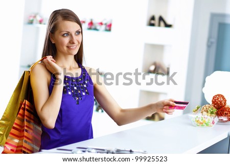 Young pretty woman doing shopping with credit card