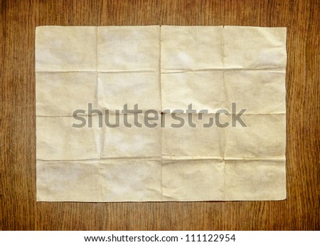 Old white paper sheet on wooden table