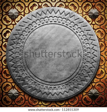 Round metal plate on carved wooden background