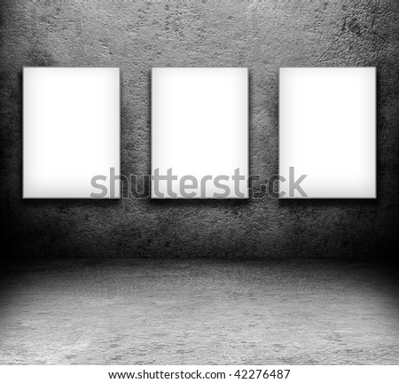 grungy black room. with three blank white screen board