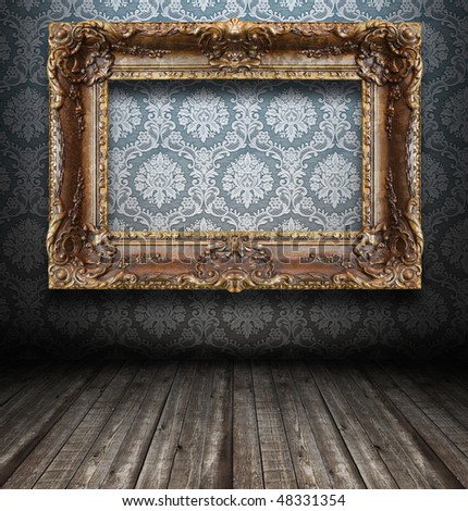 A dark, grungy room with gold frames on the wall