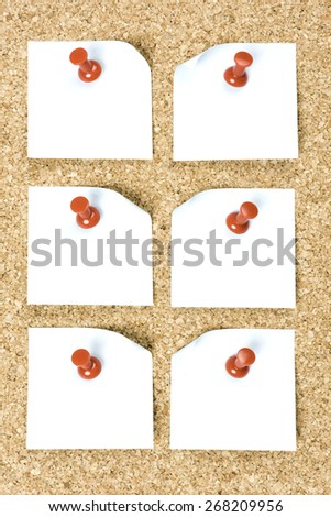 pin board with white papers and red pins